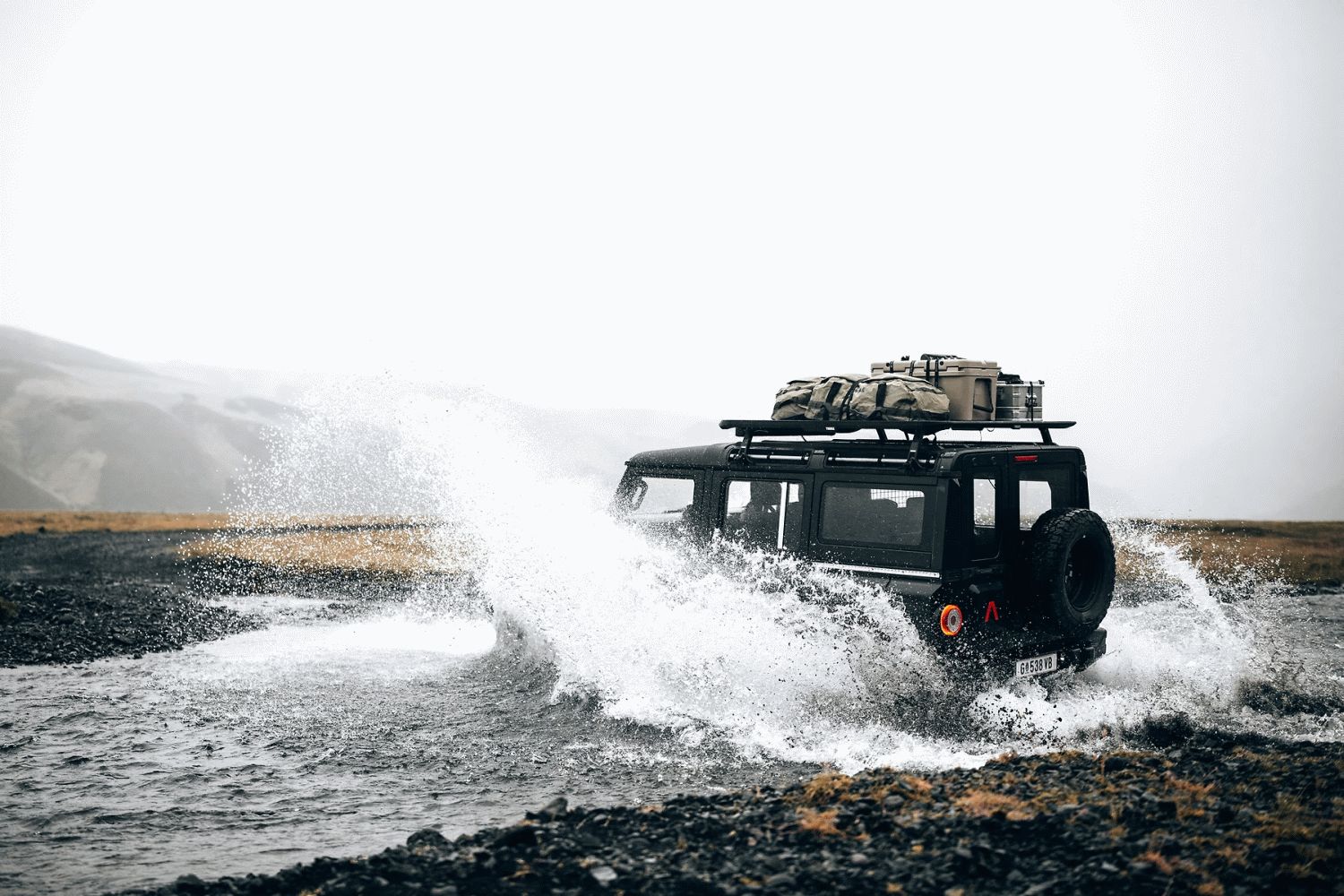 BMW Grenadiere driving through water with Thule Caprock fitted